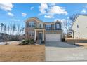 Two-story house with gray siding, brick accents, and a two-car garage at 13303 Hyperion Hills Ln, Charlotte, NC 28278