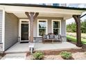 Inviting front porch with stone accents, wooden columns, and a cozy bench for relaxing at 136 Longwood Rd # 47, Mooresville, NC 28115