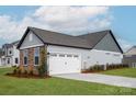 Spacious two-car garage with white door, stone accents, and well-maintained landscaping at 1846 Yardley St, Rock Hill, SC 29732