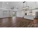 Spacious living room featuring modern lighting, wood floors, and an open layout to the kitchen area at 1846 Yardley St, Rock Hill, SC 29732