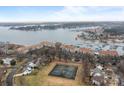 Stunning aerial view of waterfront property and tennis courts at 18669 Vineyard Point Ln, Cornelius, NC 28031