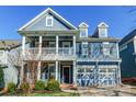 Two-story home with a front porch, white columns, and a two-car garage at 2008 Fallondale Rd, Waxhaw, NC 28173