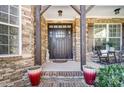 Inviting front porch with stonework and a dark wood door at 217 Ridge Reserve Dr, Lake Wylie, SC 29710