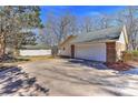 Exterior shot of a detached garage with an extended driveway and brick accents at 2205 E Brief Rd, Monroe, NC 28110