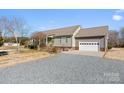 House exterior showcasing a green exterior and gravel driveway at 261 Nabors Rd, Statesville, NC 28677