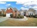 Attractive ranch home features a two-toned exterior and manicured landscaping at 3024 Ambleside Dr, Fort Mill, SC 29707