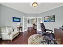 Home office features built-in shelving, hardwood floors, and French doors at 3024 Ambleside Dr, Fort Mill, SC 29707