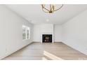 Bright living room with fireplace, hardwood floors, and chandelier at 3040 Swallowtail Ln # 36, Kannapolis, NC 28083