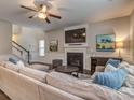 Spacious living room featuring a fireplace, large sectional sofa, and a mounted TV at 3203 Morgan Clark Rd, Charlotte, NC 28208