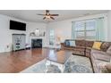 Living room features hardwood floors, a fireplace, and a comfortable sectional sofa at 3322 Yarmouth Ln, Gastonia, NC 28056