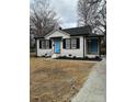 Charming renovated home with blue door, white siding, and landscaped yard at 407 E Talleyrand Ave, Monroe, NC 28112