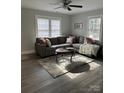 Spacious living room featuring a sectional sofa and large windows at 407 E Talleyrand Ave, Monroe, NC 28112