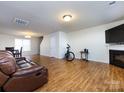 Living room with hardwood floors, fireplace, and a view of the dining area at 4529 Esmeralda Dr, Charlotte, NC 28269