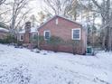 Brick home side view with snowy yard at 48374 Pfeiffer Pl, Misenheimer, NC 28109