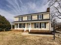 Inviting two-story home featuring a covered front porch and well-maintained landscaping at 509 Baucom Deese Rd, Monroe, NC 28110