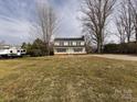 Wide shot of a two-story home with ample parking space on a spacious grassy yard at 509 Baucom Deese Rd, Monroe, NC 28110