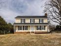 Two-story house with beige vinyl siding, dark shutters, and a brick foundation at 509 Baucom Deese Rd, Monroe, NC 28110