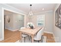 Light and airy dining area with a rustic wooden table at 532 Scaleybark Rd, Charlotte, NC 28209