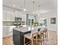 Modern kitchen with white cabinets, island, and stainless steel appliances at 5514 Galloway Dr # 63P, Stanfield, NC 28163