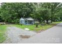 Newly renovated home with gravel driveway and mature trees at 700 Oak St, Charlotte, NC 28214