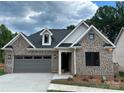 Two-story home with brick exterior, gray accents, and a two-car garage at #77 Silver Trace Ln, Denver, NC 28037