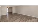 Spacious living room featuring neutral walls and wood-look flooring at 9153 Spyglass Pl # B, Charlotte, NC 28214