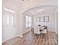 Bright dining room with hardwood floors and a modern table at 9806 Penn Station St, Cornelius, NC 28031