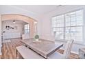 Bright dining room with hardwood floors and a modern table at 9806 Penn Station St, Cornelius, NC 28031