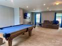 Spacious game room with a pool table, TV, and comfortable seating area at 1148 Tangle Ridge Se Dr, Concord, NC 28025