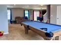 Large game room featuring a pool table and an adjacent dining area near the sliding door at 1148 Tangle Ridge Se Dr, Concord, NC 28025