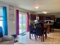 Eat-in kitchen with dark cabinets, stainless appliances, and sliding door to the backyard at 1148 Tangle Ridge Se Dr, Concord, NC 28025