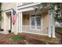 Cozy covered porch with white railings, perfect for relaxing at 13228 Kennerly Dr, Huntersville, NC 28078