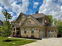 Beautiful brick home with attached two-car garage and well-manicured lawn at 14018 Promenade Dr, Huntersville, NC 28078