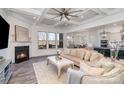 Elegant living room with coffered ceiling, fireplace, and views to the backyard at 14018 Promenade Dr, Huntersville, NC 28078
