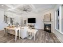 Comfortable living room featuring a fireplace, hardwood floors, and an open layout at 14018 Promenade Dr, Huntersville, NC 28078