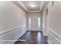 Inviting entryway featuring a white front door with sidelights, hardwood flooring, and white wainscoting at 148 Prestwick Way # 21, Mooresville, NC 28115