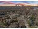 Stunning aerial view showcases the city skyline and the surrounding neighborhoods and beautiful trees at 186 Cherokee Rd, Charlotte, NC 28207