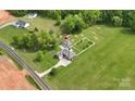 Expansive property featuring a well-manicured lawn, detached garage and ample space at 219 Society Rd, Statesville, NC 28625