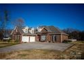 Charming brick home with a three car garage, mature landscaping and well-manicured lawn at 219 Society Rd, Statesville, NC 28625