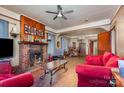 An inviting living room with a brick fireplace, wood floors, and views into the dining area at 3220 Harmony Hwy, Harmony, NC 28634