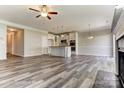 Open-concept kitchen and living space with center island, stainless appliances, and hardwood floors at 4013 Grace Pointe Dr # 102, Wesley Chapel, NC 28079