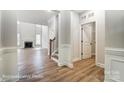 Bright living room featuring wood floors, a fireplace, and staircase access at 5108 Verona Rd # 94, Charlotte, NC 28213
