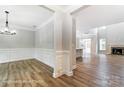Spacious open-concept living room with wood floors, fireplace, and dining area at 5108 Verona Rd # 94, Charlotte, NC 28213