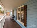 Inviting front porch with wooden railings and two chairs at 521 Mountainview Dr, Charlotte, NC 28270