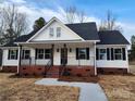 Charming new construction home boasts a inviting front porch with metal railing and brick accents at 522 Birdie Haven Dr # 27, Chester, SC 29706