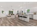 Bright, open-concept living room and kitchen with stainless steel appliances and modern finishes at 5615 Howard St, Charlotte, NC 28269