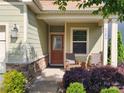 Welcoming front entrance with a cozy seating area and manicured garden at 6289 Raven Rock Dr, Denver, NC 28037