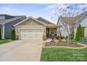 Charming single-story home boasts a two-car garage, manicured lawn, and tasteful landscaping at 6289 Raven Rock Dr, Denver, NC 28037