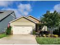 Charming home featuring a two-car garage and well-manicured front yard at 6289 Raven Rock Dr, Denver, NC 28037