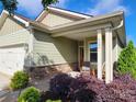 Inviting front porch with seating area framed by lush landscaping at 6289 Raven Rock Dr, Denver, NC 28037